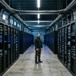 Technicus in een groot datacenter met rijen serverracks, symbool voor AI-investeringen en de chipmarkt